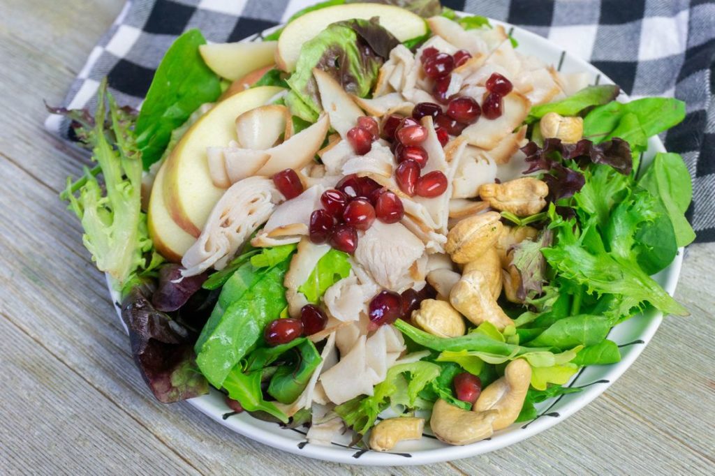 Thanksgiving Fall Harvest Salad on Gray Wood With Plaid Napkin