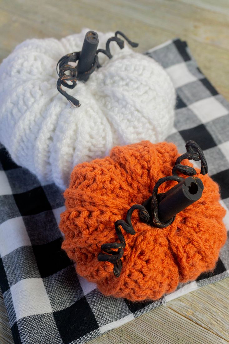 Farmhouse Crochet Pumpkins on plaid and gray wood.