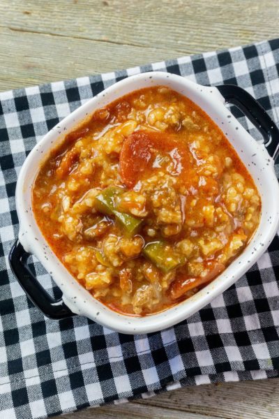 Instant Pot Czech Stuffed Pepper Soup in a black and white bowl on a black and white plaid napkin