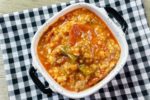 Instant Pot Czech Stuffed Pepper Soup in a black and white bowl on a black and white plaid napkin