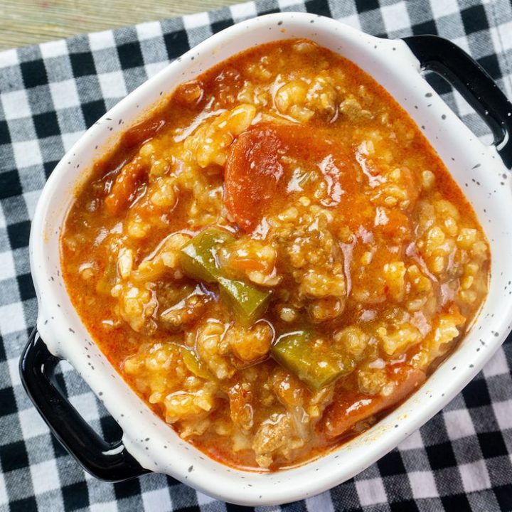 Instant Pot Czech Stuffed Pepper Soup in a black and white bowl on a black and white plaid napkin