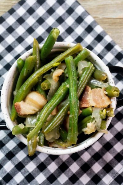 Instant Pot Bacon Green Beans inside a black and white bowl on a plaid napkin