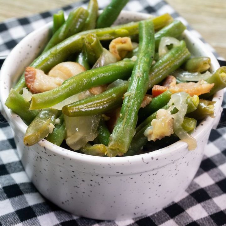 Instant Pot Bacon Green Beans inside a black and white bowl on a plaid napkin