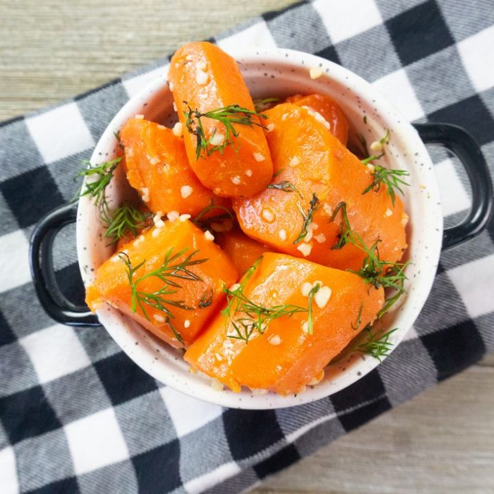 Instant Pot Garlic Dill Carrots on grey wood in a white bowl