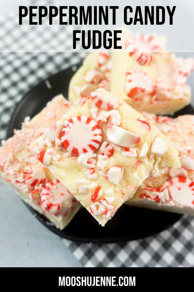 Peppermint candy fudge on a black plate with gray plaid napkin on a concrete backdrop