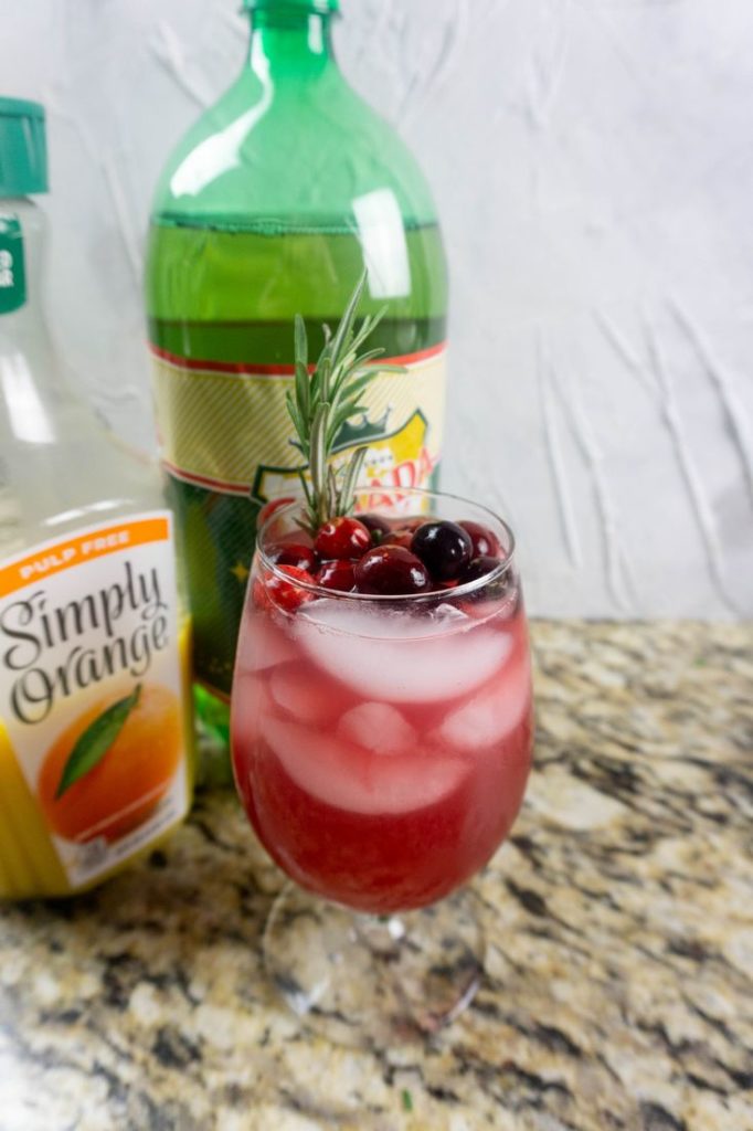 Ingredients like cranberry juice, orange juice, and ginger ale to make the Rudolph spritzer. 